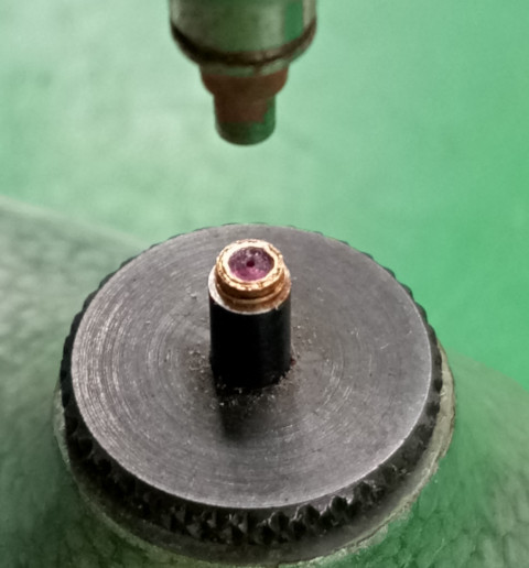 Pressing the stone into the brass lining.